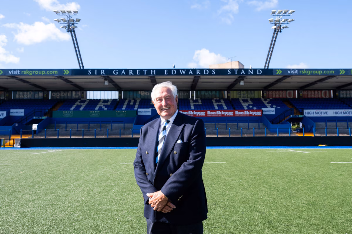 Sir Gareth Edwards standing at the Arms Park in front of the newly named stand after him